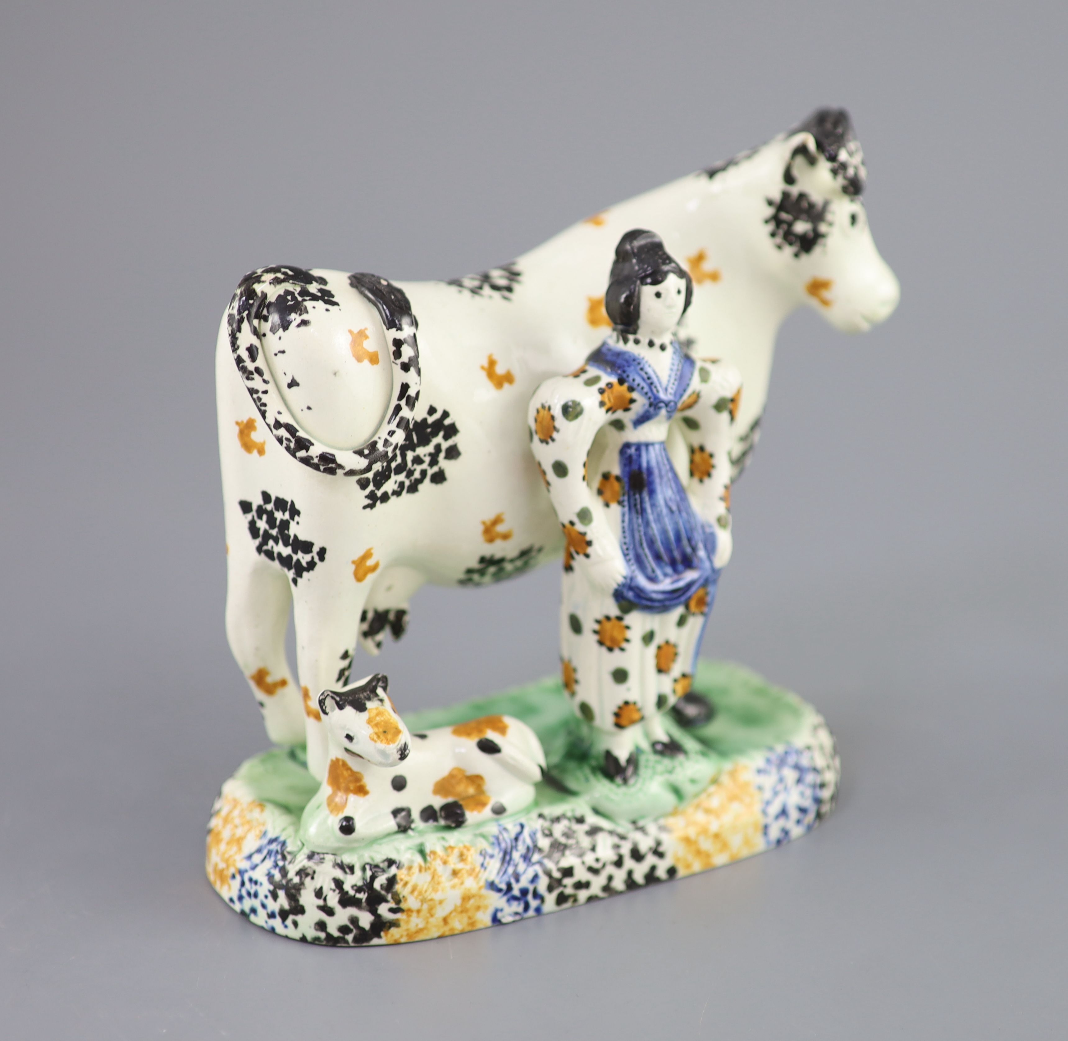A Yorkshire Prattware cow and milkmaid group, probably Mexborough, c.1820, 15cm high, 16cm long